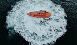 Orange workboat in the water